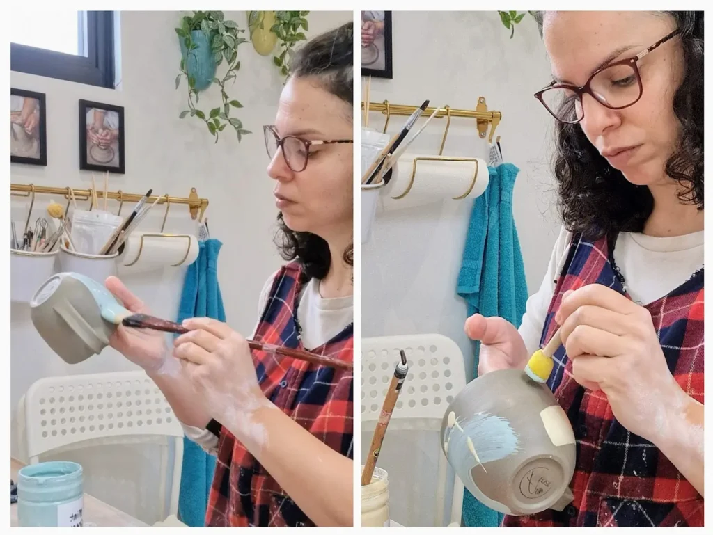 Applying colorful underglazes and to a handmade pottery mug using a brush and sponge.